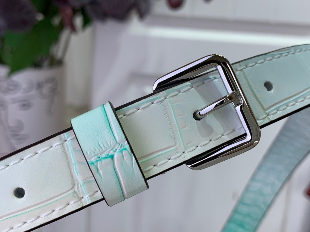 Light blue crocodile-embossed strap with rectangular metal buckle