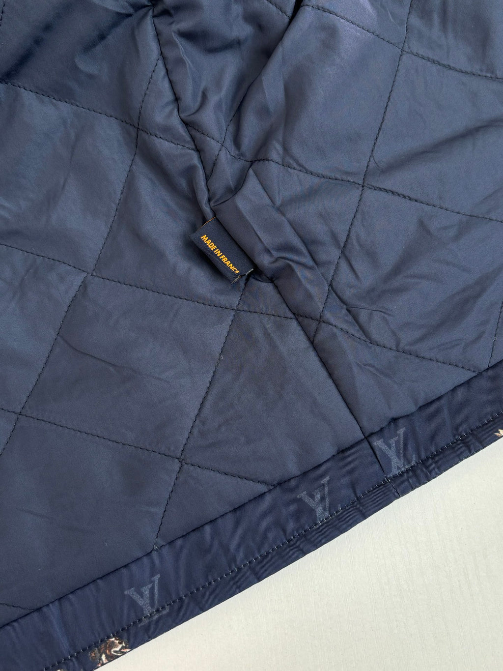Louis Vuitton quilted long jacket in dark blue with tonal monogram print and cuff trim