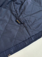 Louis Vuitton quilted long jacket in dark blue with tonal monogram print and cuff trim