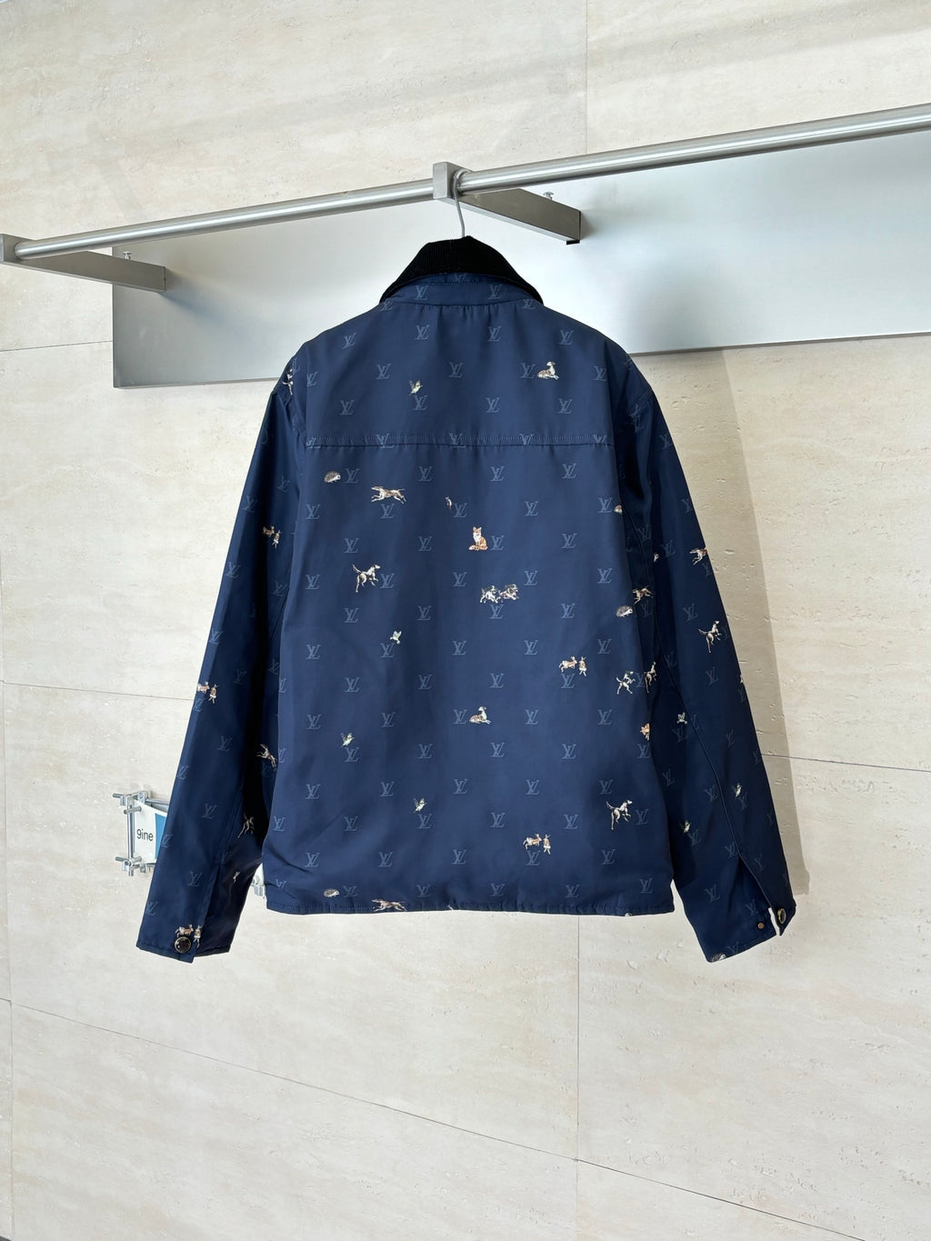 Navy Louis Vuitton jacket back view with allover monogram and rider motif