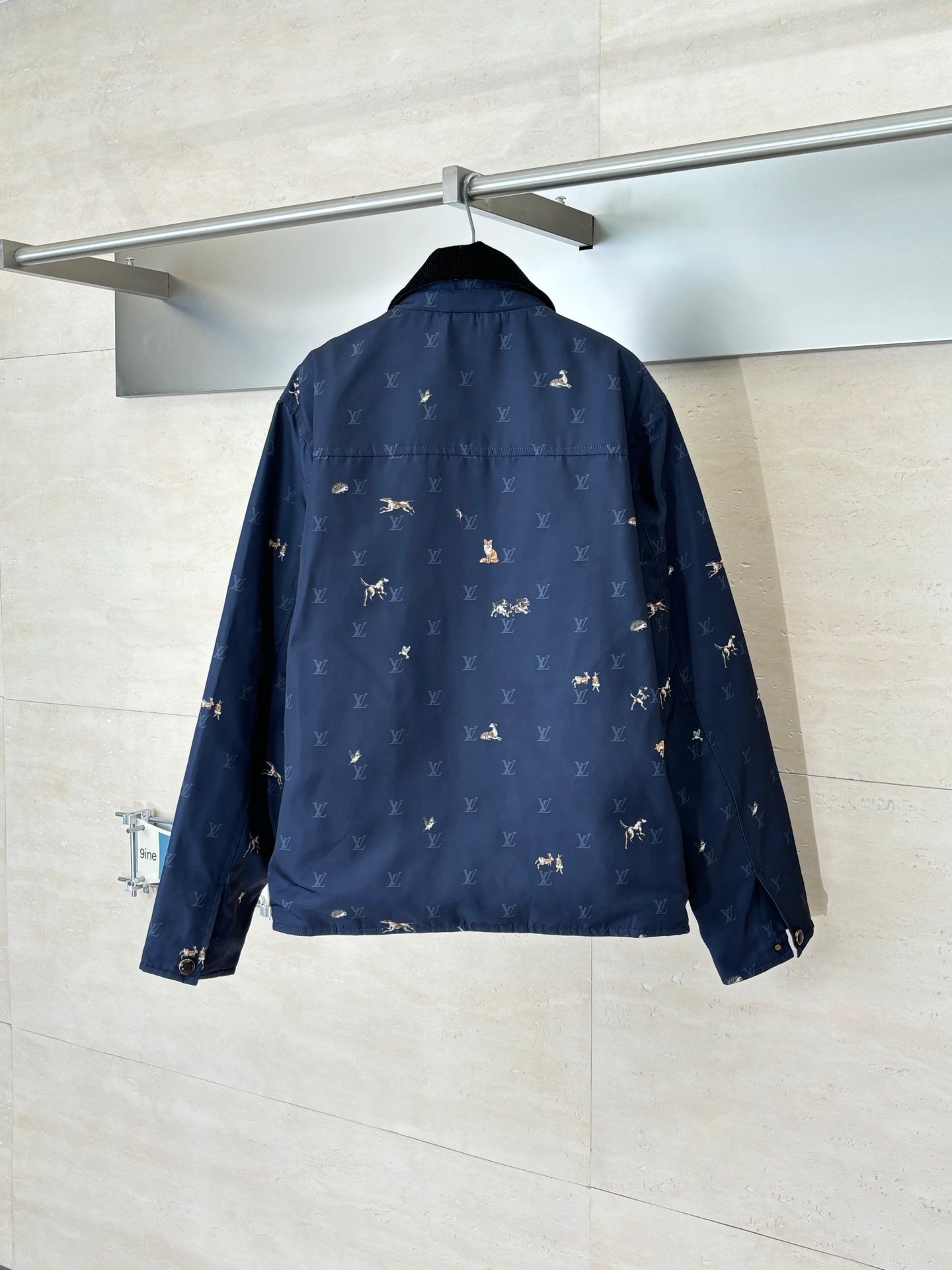 Navy Louis Vuitton jacket back view with allover monogram and rider motif