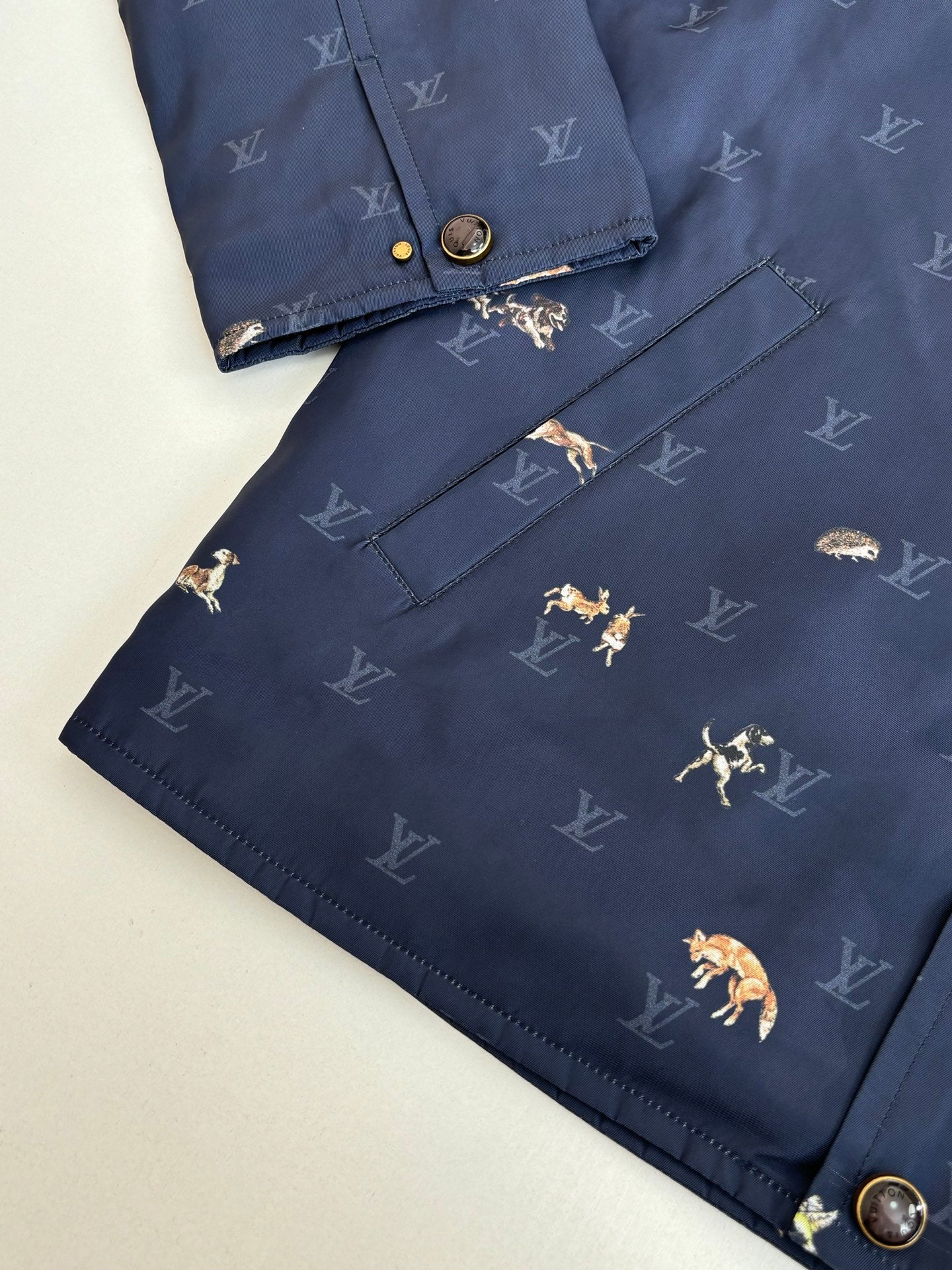 Navy Louis Vuitton jacket with flap-style chest pocket and allover monogram print