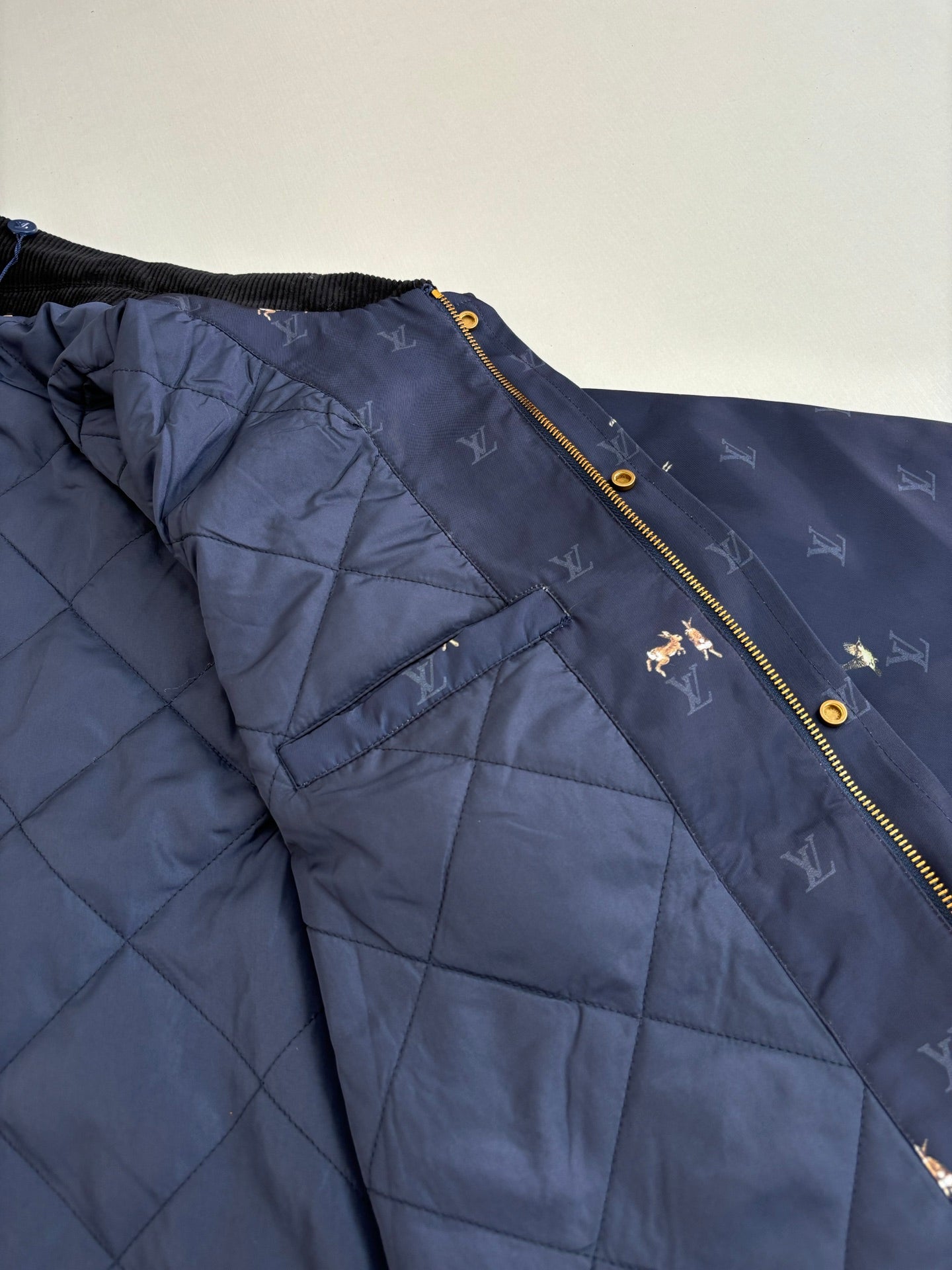 Navy Louis Vuitton puffer lining with quilted panels and gold zipper edge