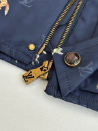 Navy Louis Vuitton jacket cuff with gold zipper pulls and round logo buttons
