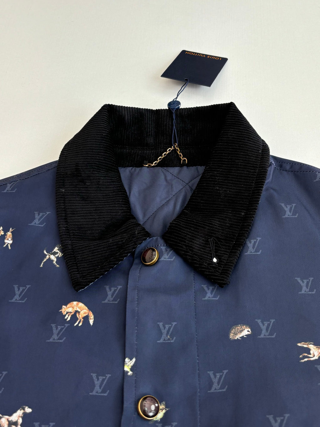 Navy Louis Vuitton jacket with black corduroy collar and gold button details
