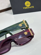 Versace sunglasses with green and purple frames, each with gold temple hardware