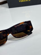 Versace sunglasses close-up with dark tortoise frames and tinted lenses