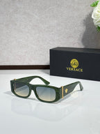 Versace sunglasses with green frames, gold temple accents, and dark tinted lenses