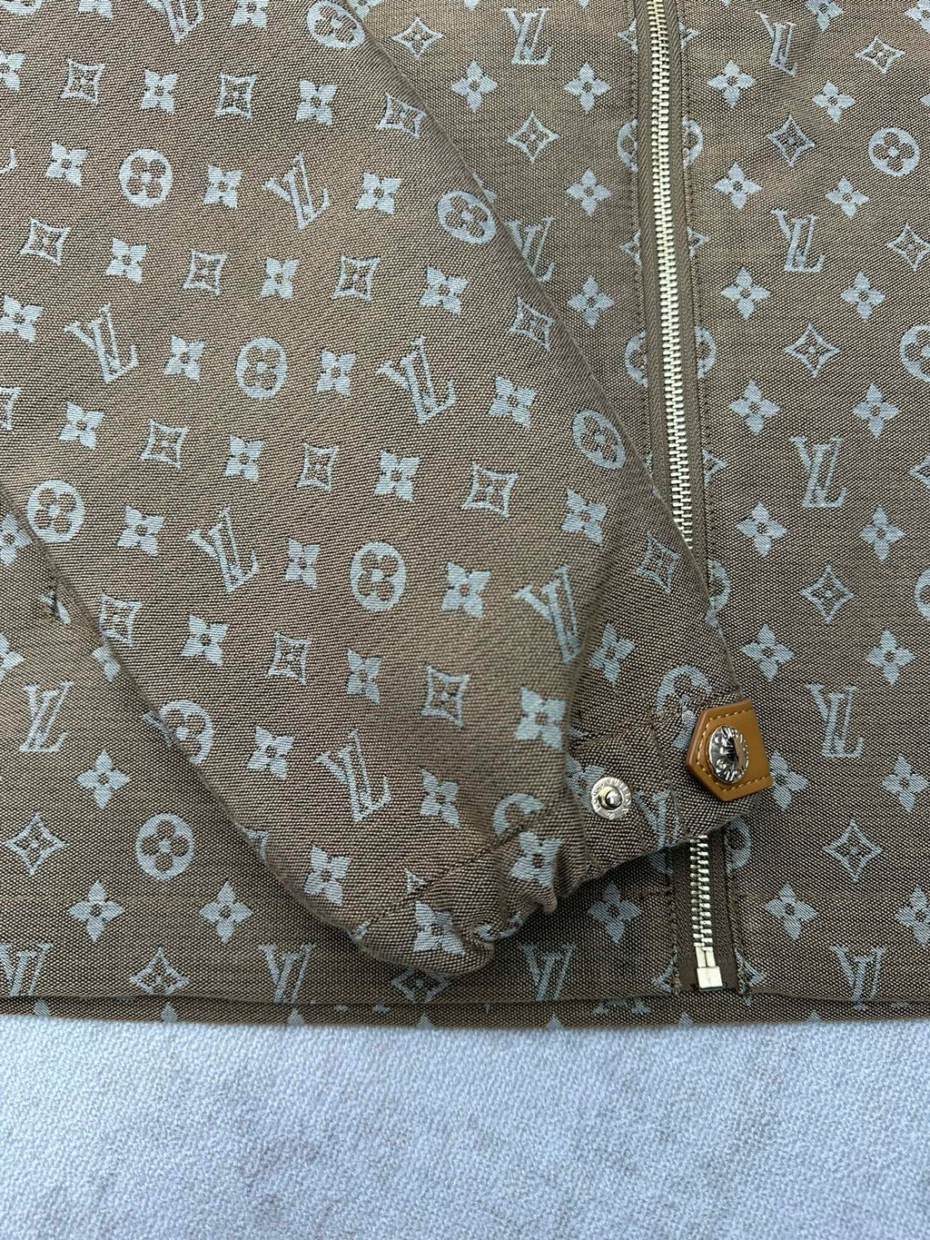 Zip-front and lower button placket detail on monogram jacket
