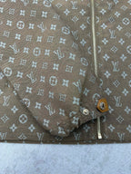Zip-front and lower button placket detail on monogram jacket