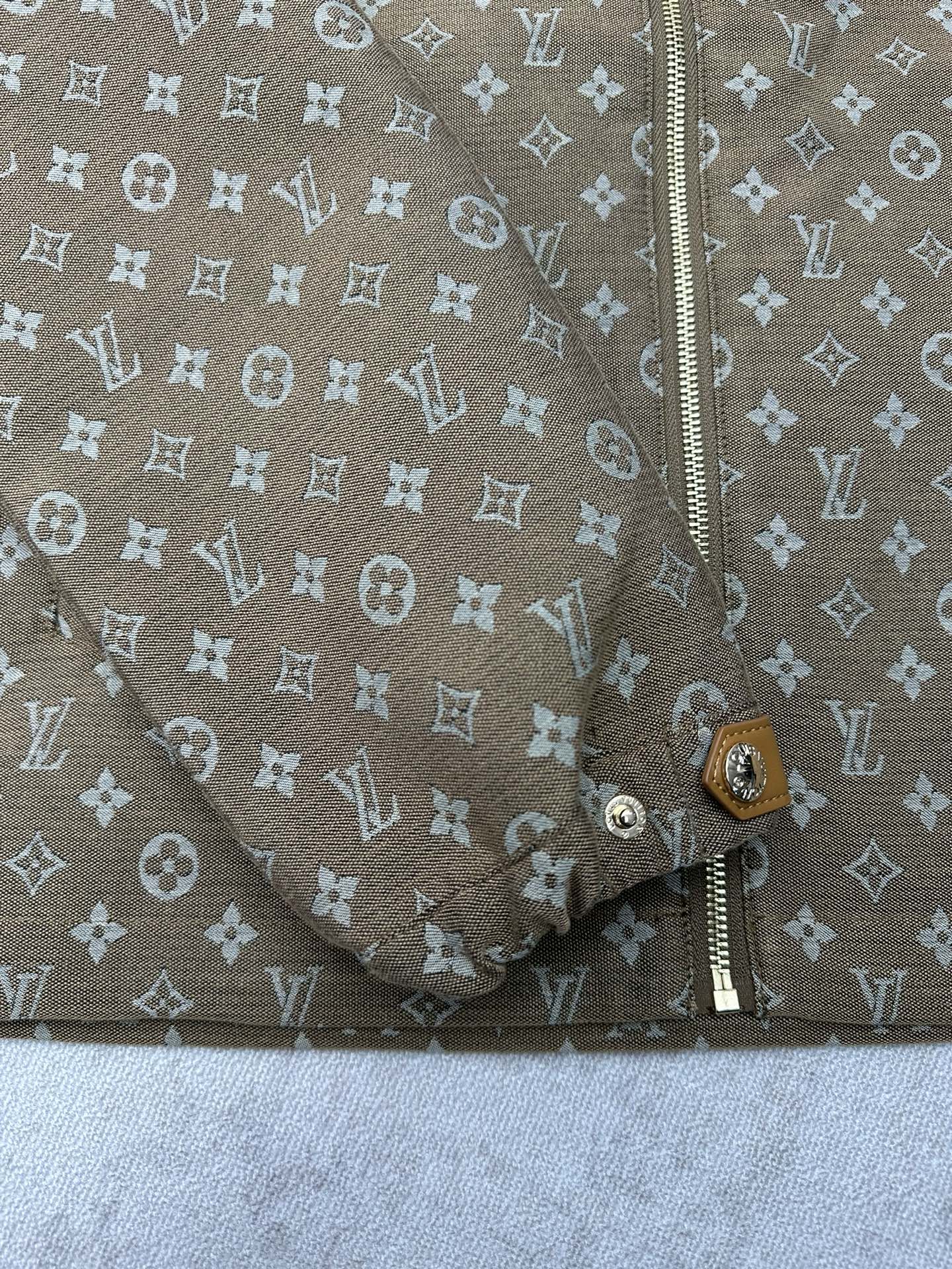 Zip-front and lower button placket detail on monogram jacket
