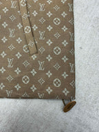 Brown monogram jacket sleeve detail with cuff and small button tab
