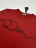 Dior red T-shirt with large black cursive logo on chest