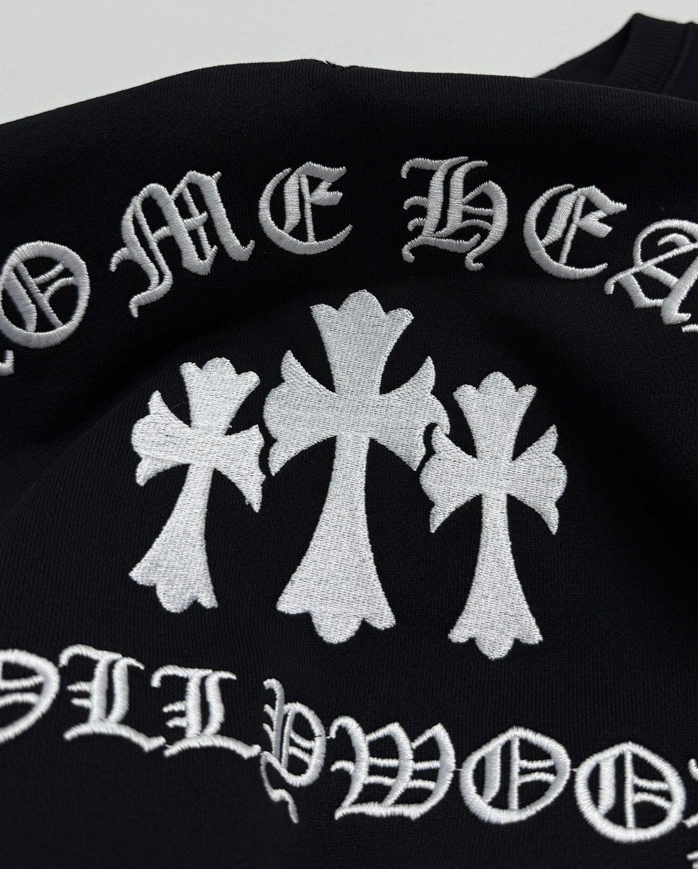 Black sweatshirt with large white flower graphic and curved text print