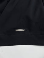 Black sweatshirt hem with small oval brand patch label