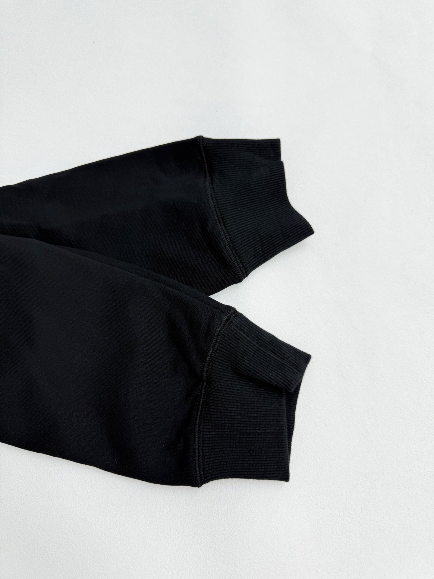 Black long-sleeve sweatshirt sleeve cuff and ribbed hem