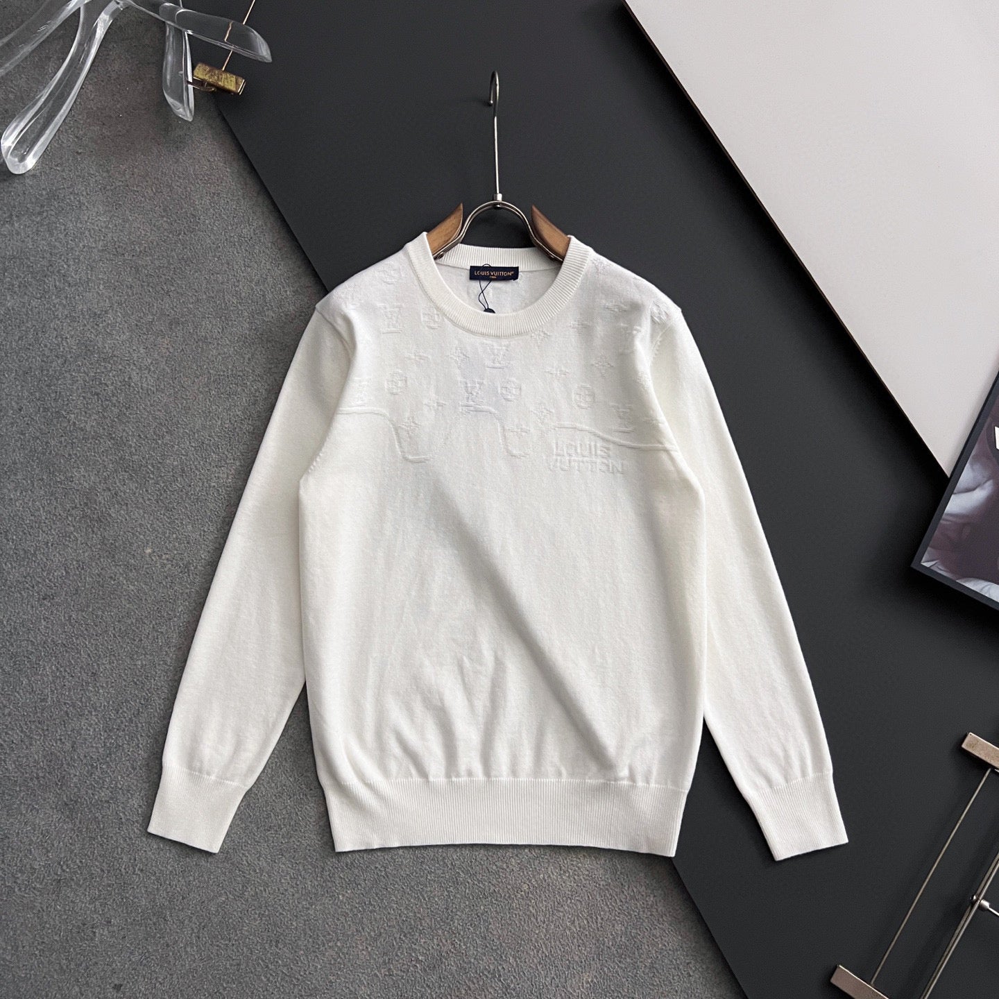 White Louis Vuitton long-sleeve crewneck sweatshirt on hanger, front view