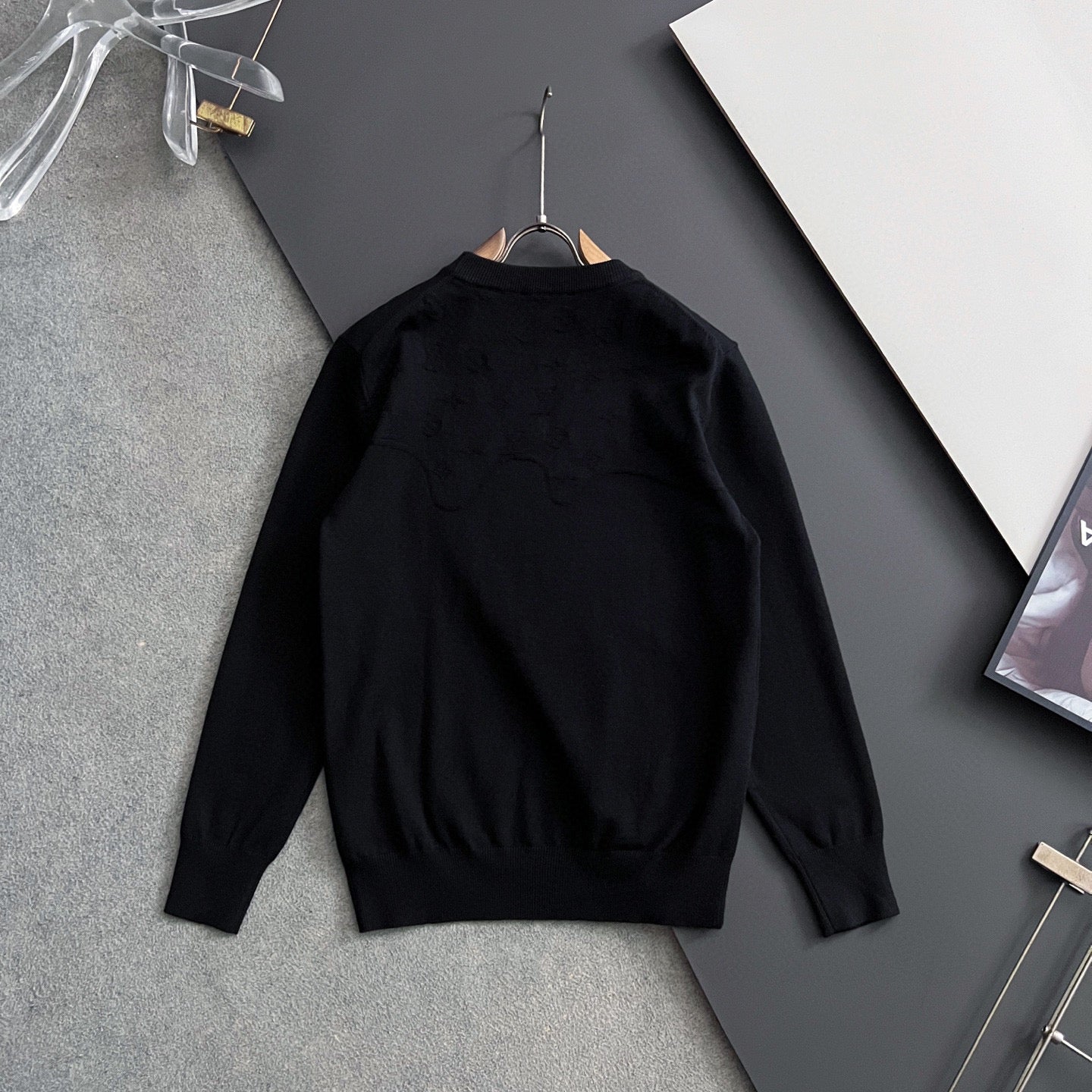 Black Louis Vuitton long-sleeve crewneck sweatshirt on hanger, back view