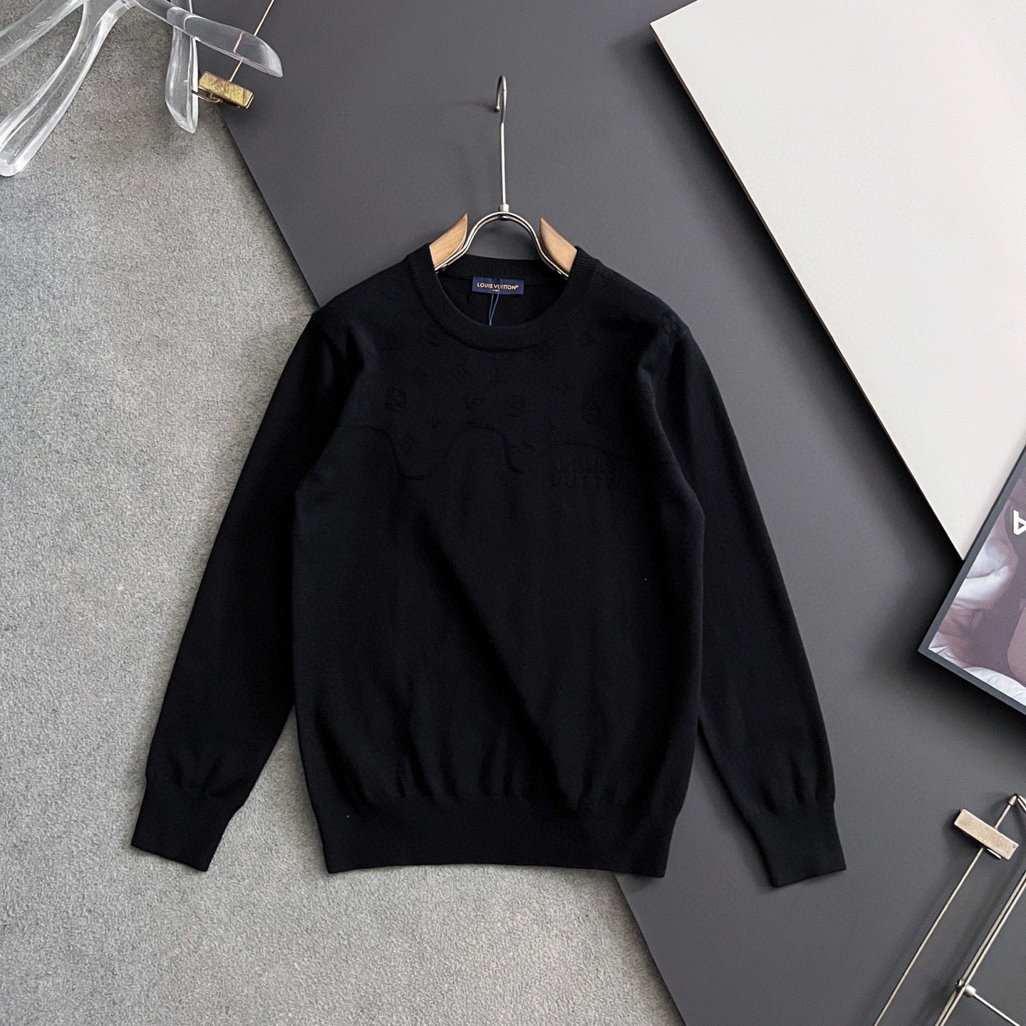 Black Louis Vuitton long-sleeve crewneck sweatshirt on hanger, front view