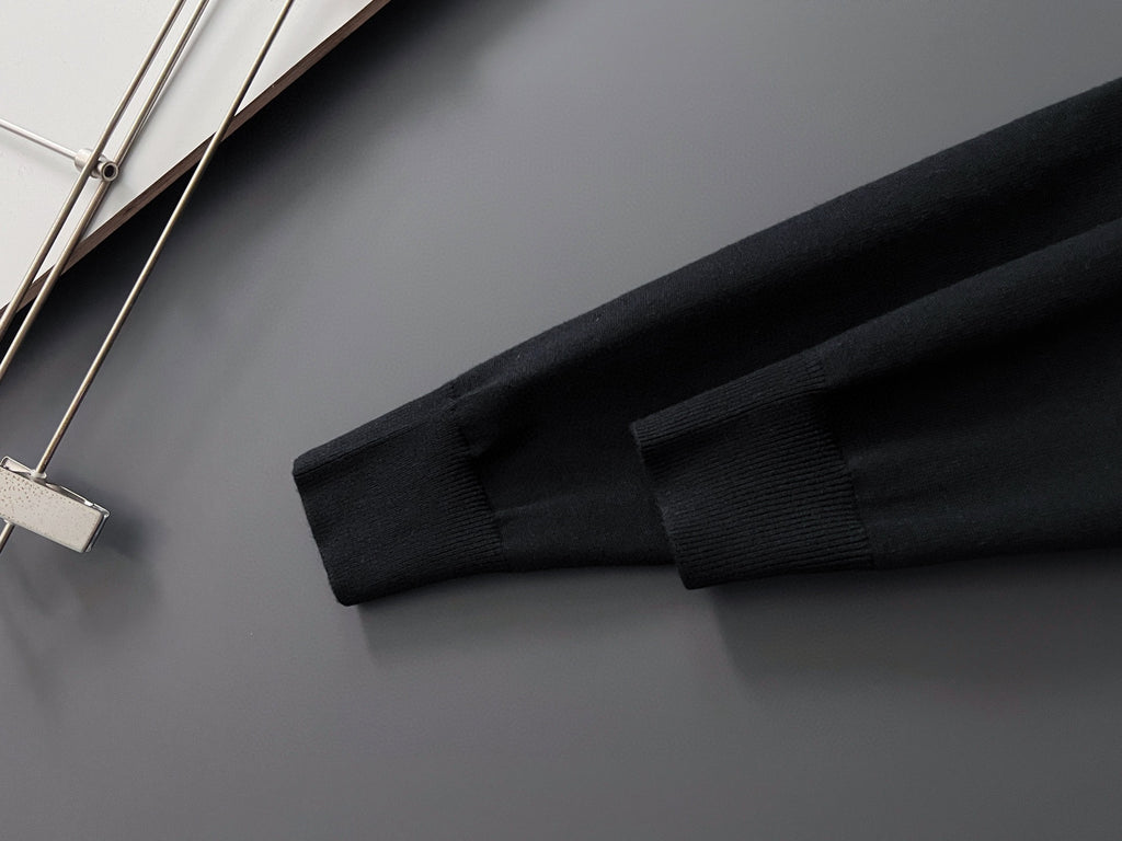 Black knit sleeve hem of Louis Vuitton sweatshirt, close-up