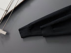 Black knit sleeve hem of Louis Vuitton sweatshirt, close-up