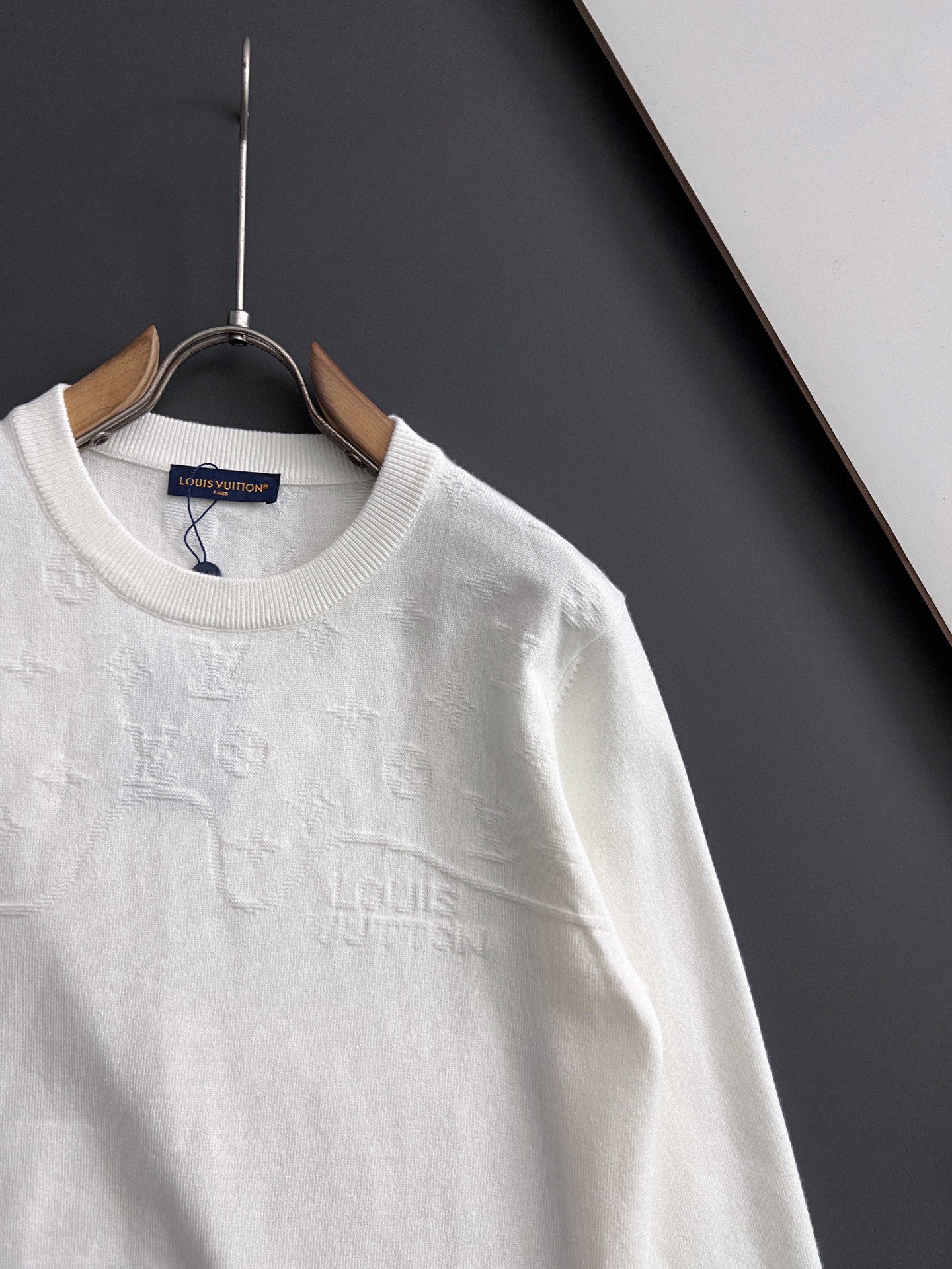 White Louis Vuitton long-sleeve crewneck sweatshirt on hanger, close front view