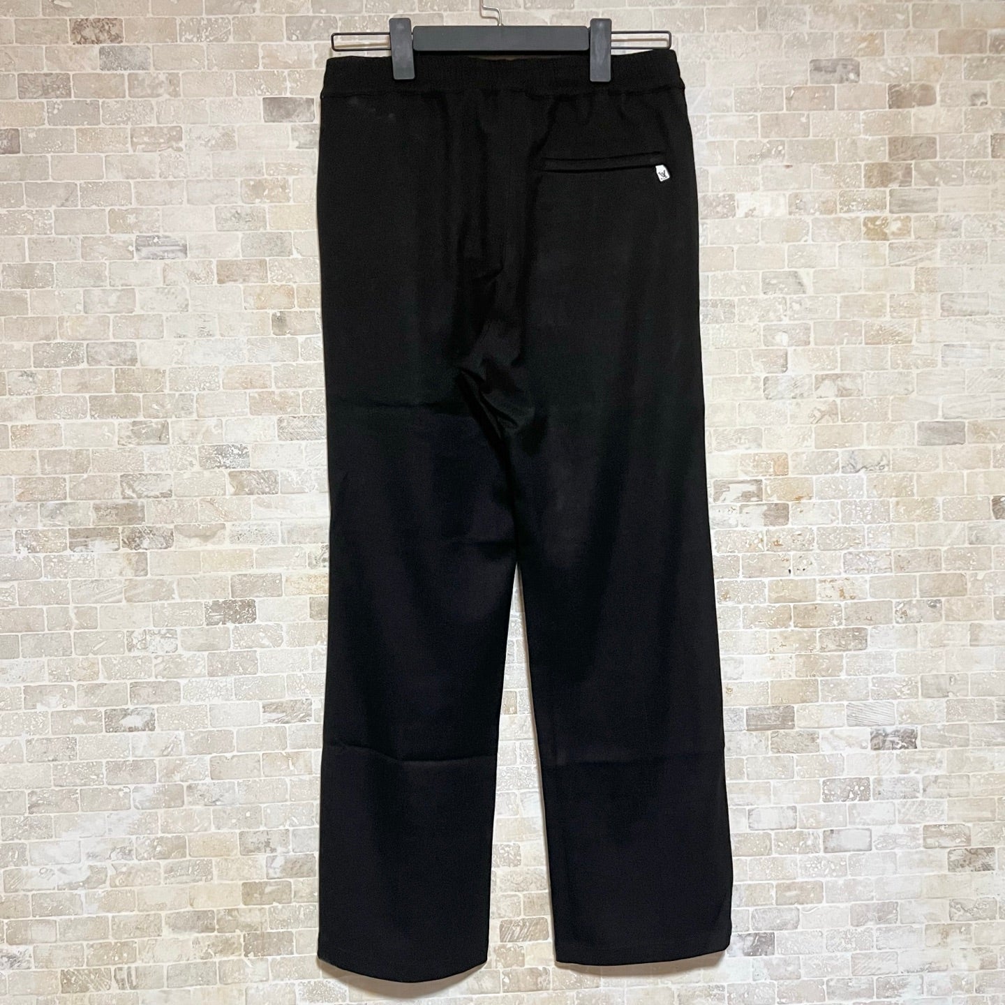 Black Louis Vuitton pants full view with elastic waistband and logo on leg