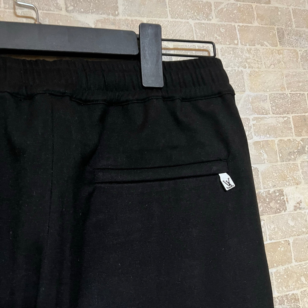 Black pants waist band with belt loops and small LV logo patch