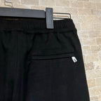 Black pants waist band with belt loops and small LV logo patch