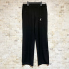 Black Louis Vuitton pants with belt loops and small gold LV logo at thigh