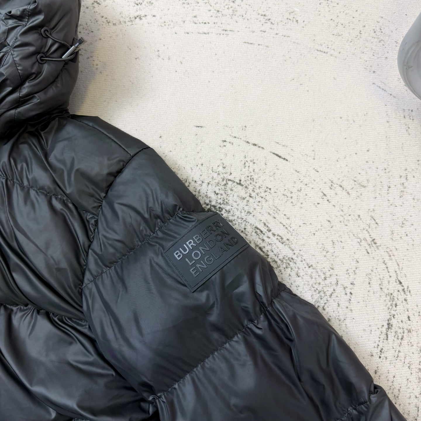 Dark puffer jacket back with Burberry LONDON logo patch