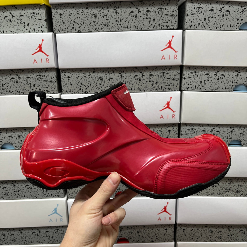 Red glossy high-top sneaker with black collar trim and curved side logo