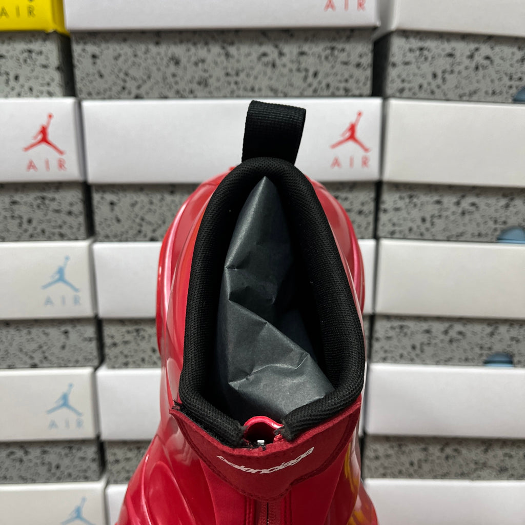 Red glossy high-top sneaker interior collar with black fabric pull strap