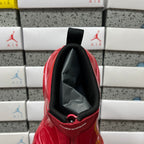Red glossy high-top sneaker interior collar with black fabric pull strap