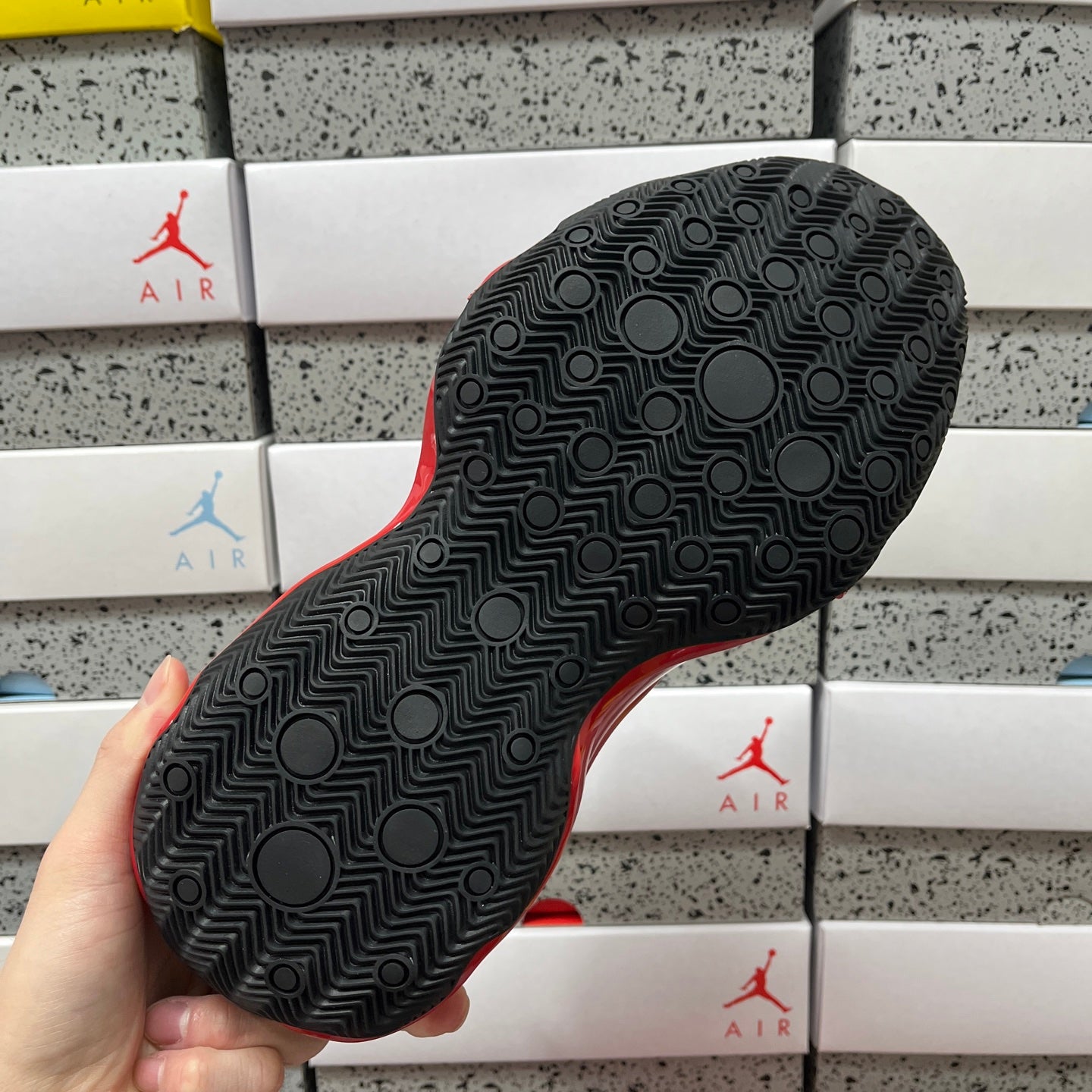 Black rubber sneaker outsole with circular and maze-like tread pattern