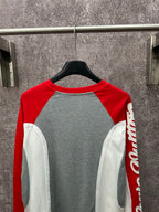 Raglan long-sleeve shirt with gray body, red sleeves, and white contrast side panels