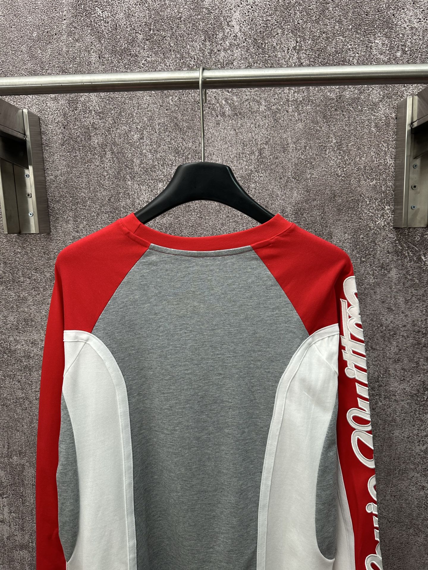 Raglan long-sleeve shirt with gray body, red sleeves, and white contrast side panels