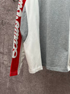 Long-sleeve raglan shirt with white side panel and red sleeve; gray main body