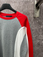 Long-sleeve raglan shirt with red shoulder panel and gray body; white sleeve inset