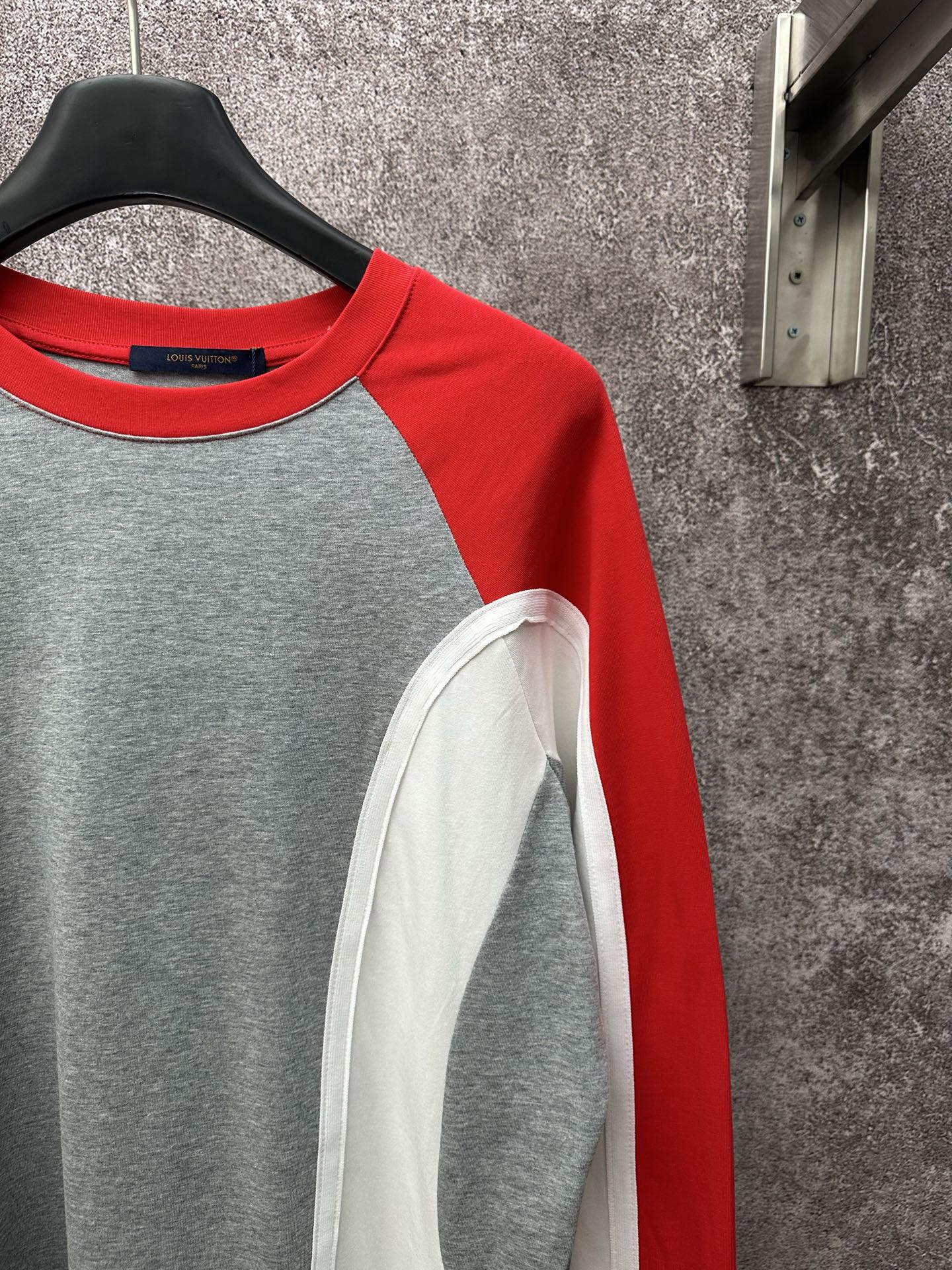 Long-sleeve raglan shirt with red shoulder panel and gray body; white sleeve inset