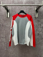 Raglan long-sleeve shirt with gray body, red sleeves, and white side panels