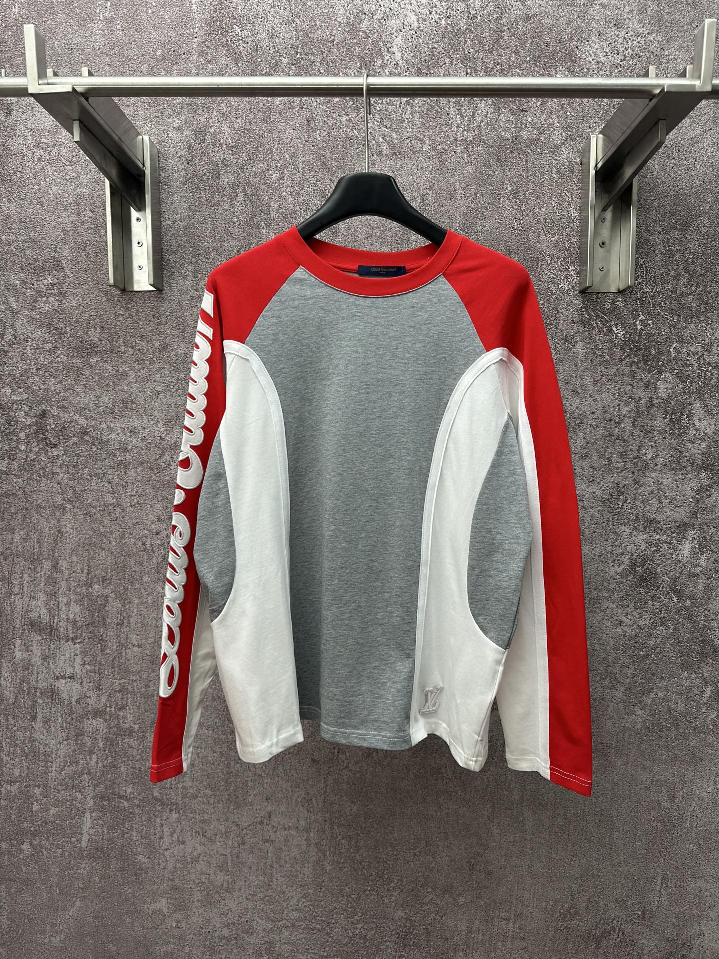 Raglan long-sleeve shirt with gray body, red sleeves, and white side panels