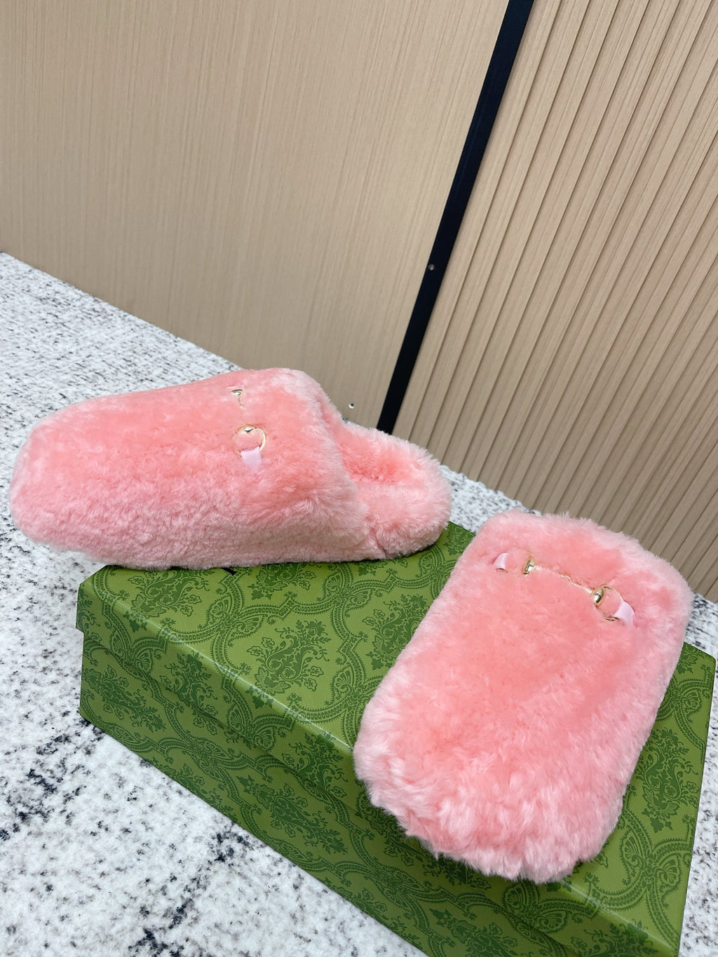 Gucci pink plush slide sandals with open top and gold-tone hardware on straps