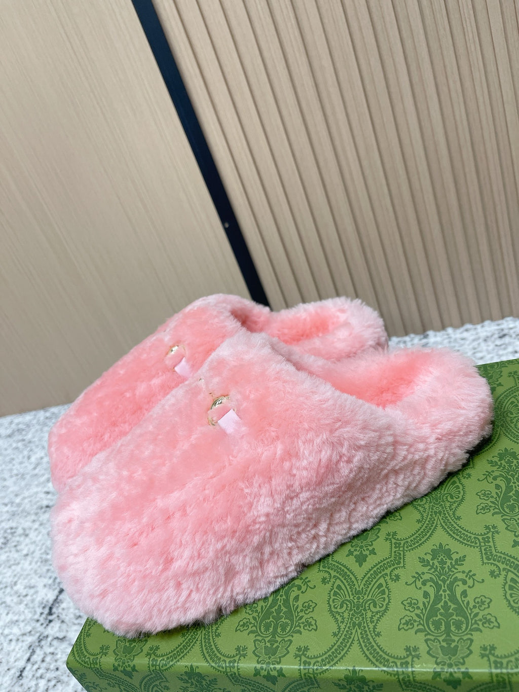 Gucci pink plush slide sandals with curled fur-like lining and gold-tone details