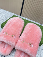 Gucci pink plush slide sandals close-up of gold-tone hardware on the front straps