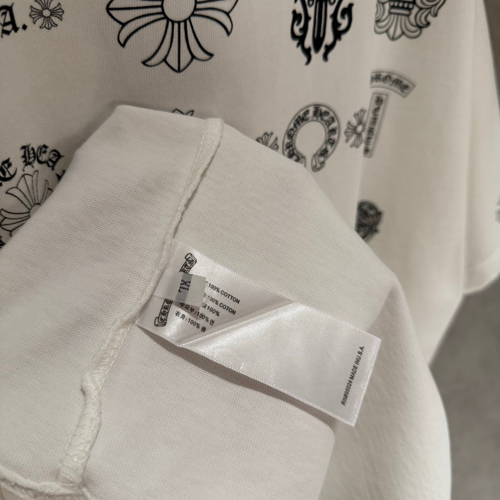 Clothing tag on white T-shirt hem, showing care and barcode label