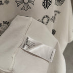 Clothing tag on white T-shirt hem, showing care and barcode label