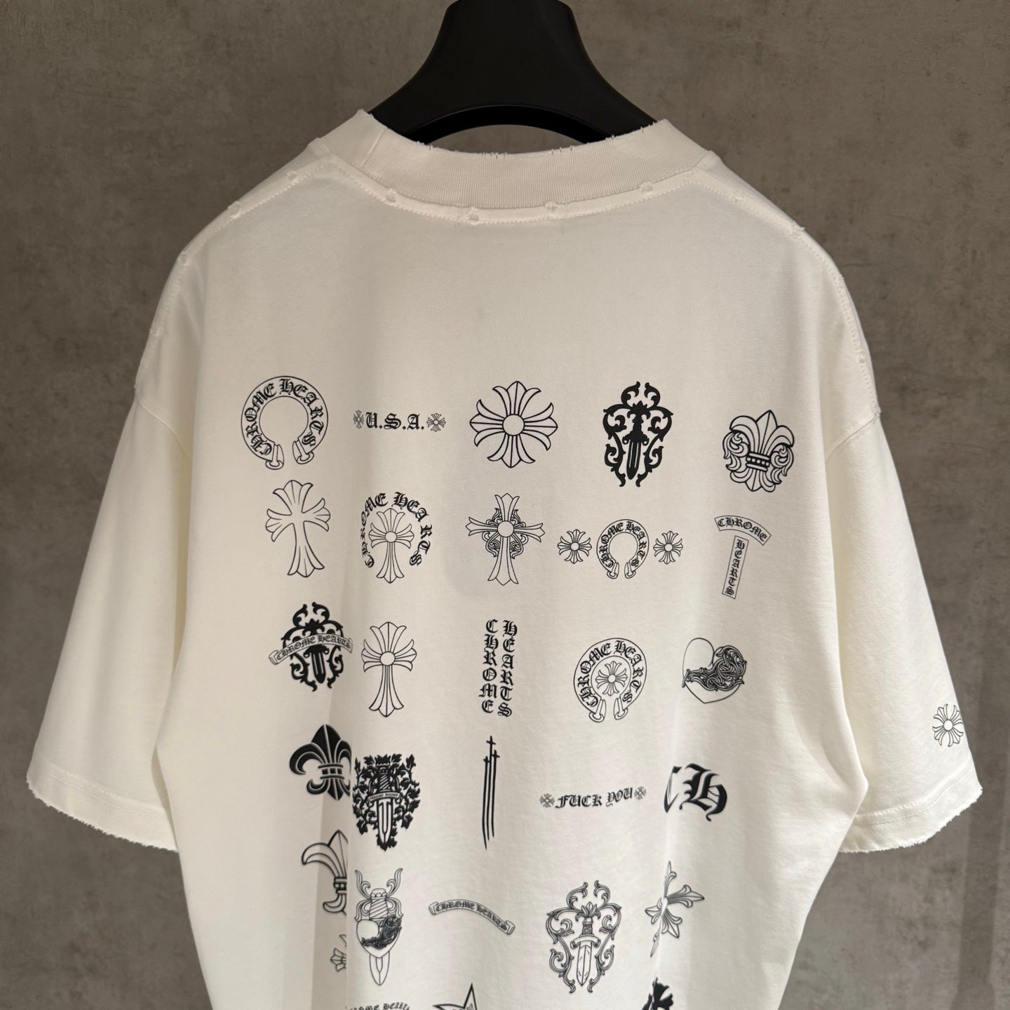 White short-sleeve T-shirt with back collage of icons and text print