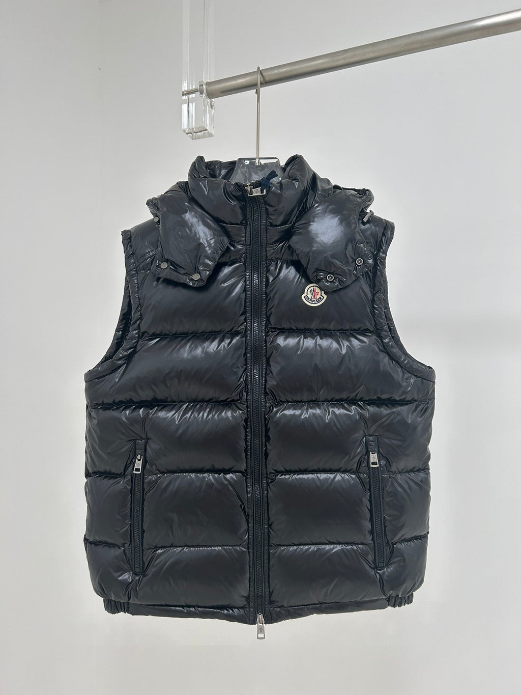 Moncler dark navy hooded puffer vest with front zipper and logo chest patch