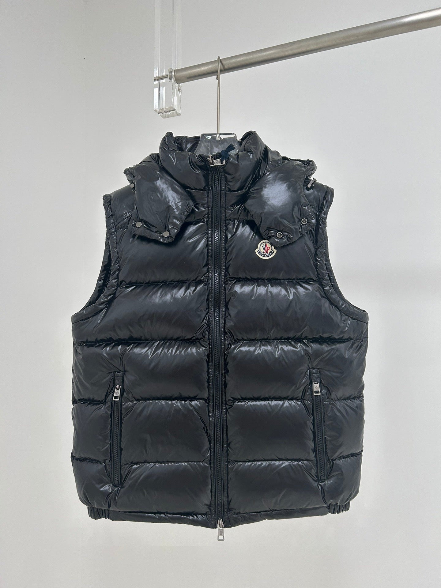 Moncler dark navy hooded puffer vest with front zipper and logo chest patch